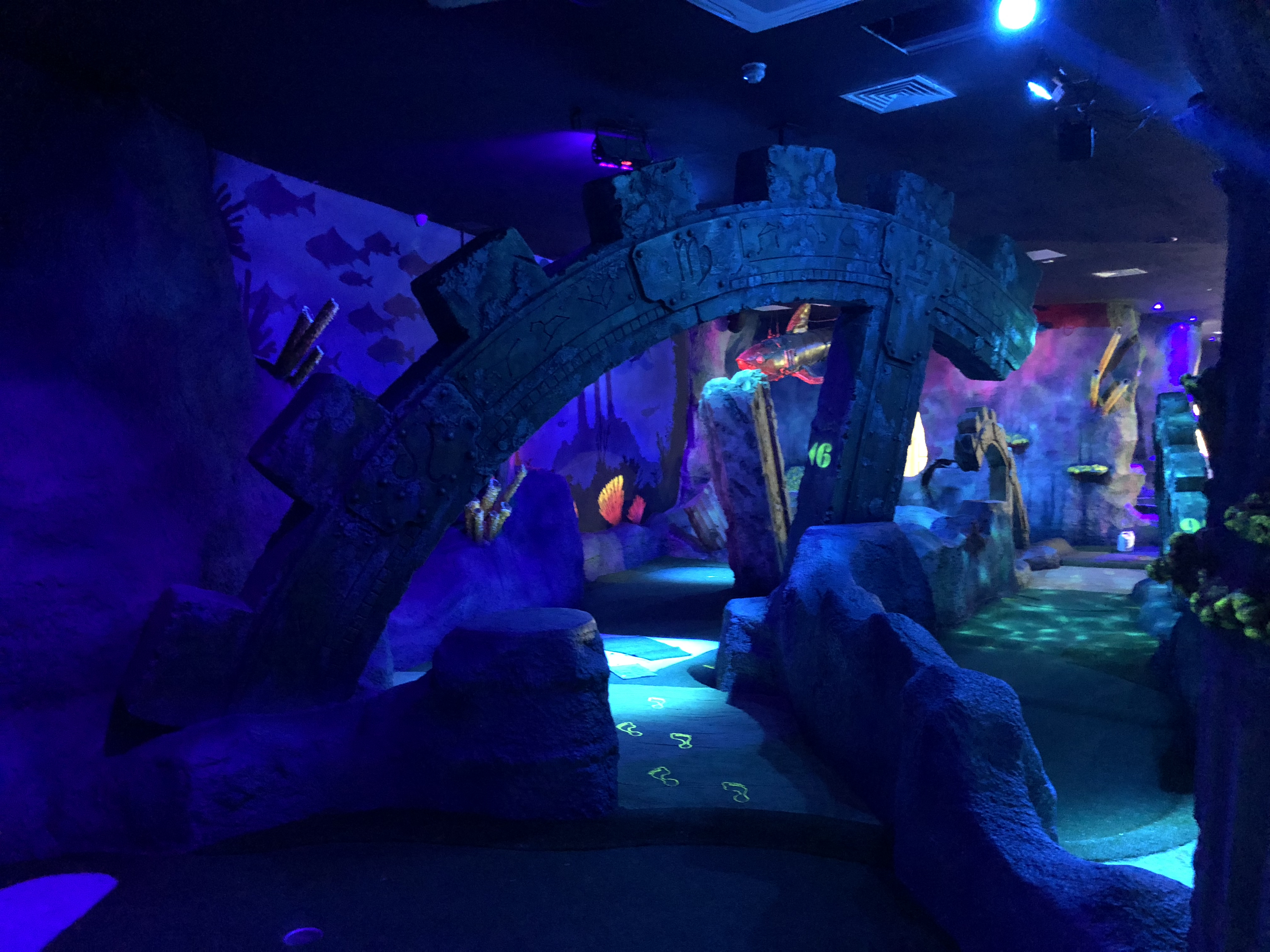 A view of the lit up underwater mini golf scene in lost world golf in Milton Keynes after the commercial fit out by RCEservices