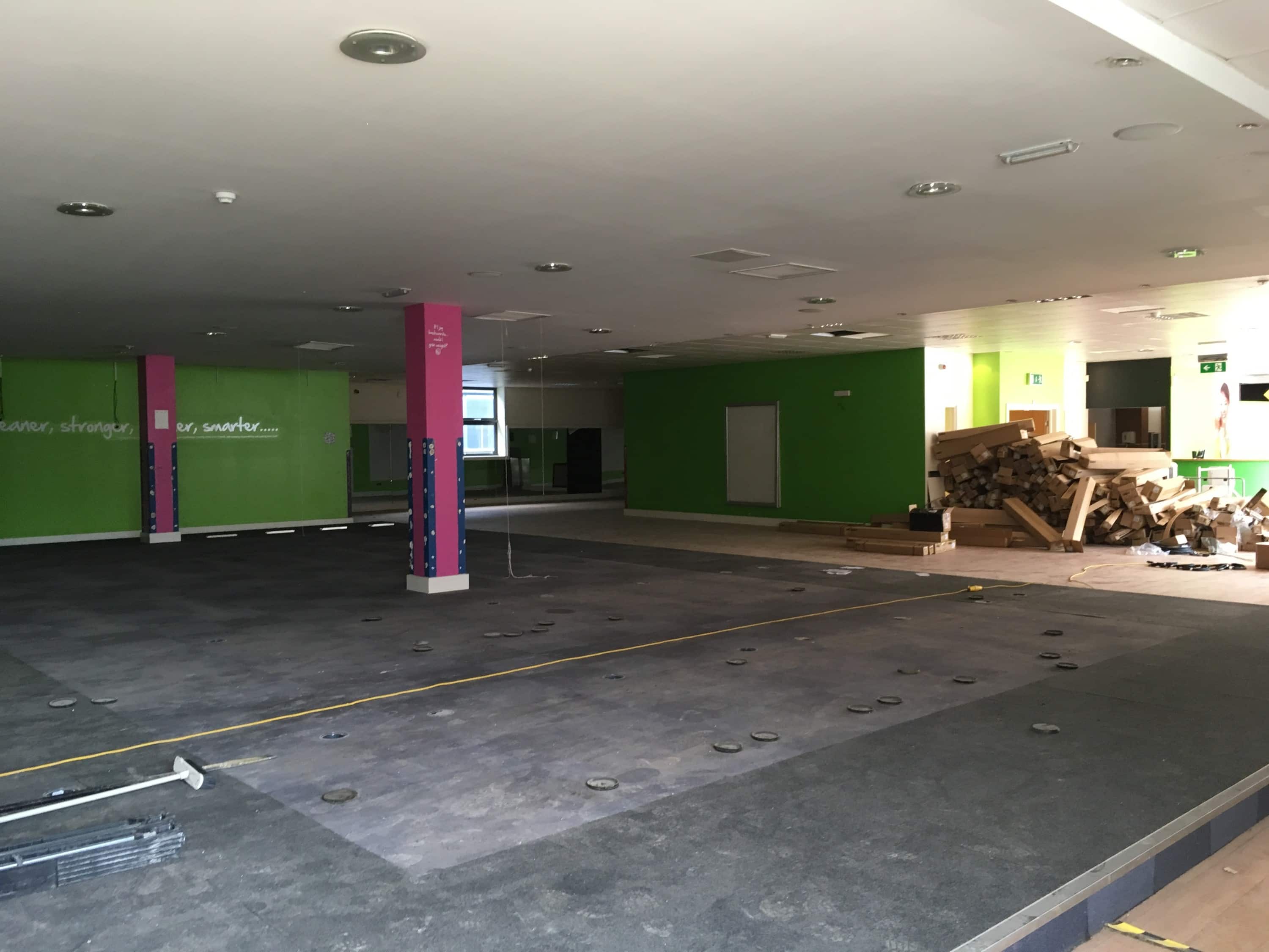 An image of the site before the fit out, depicting an empty former gym in a leisure complex in Milton Keynes